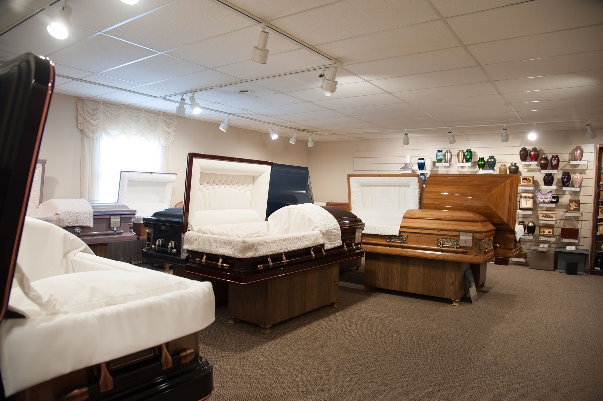 a room filled with lots of coffins and urns