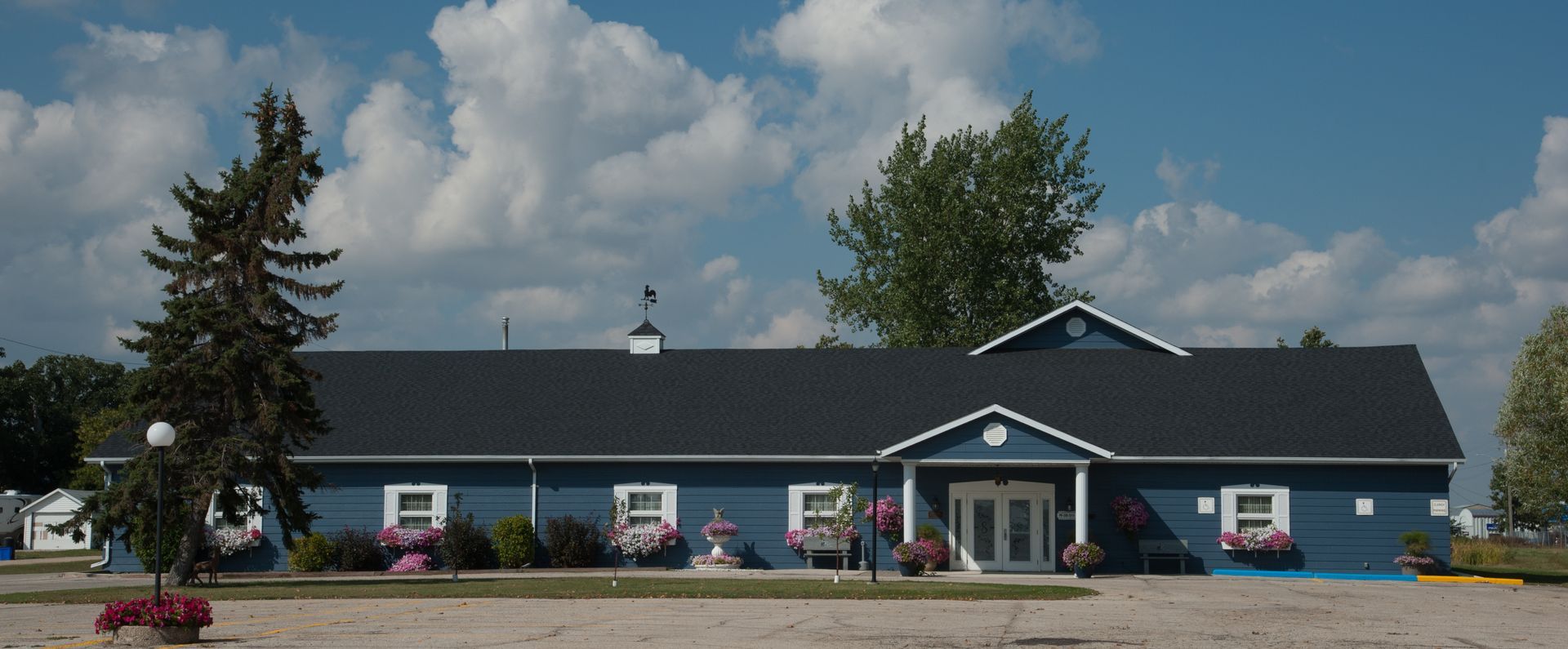 a blue building with a black roof and white trim