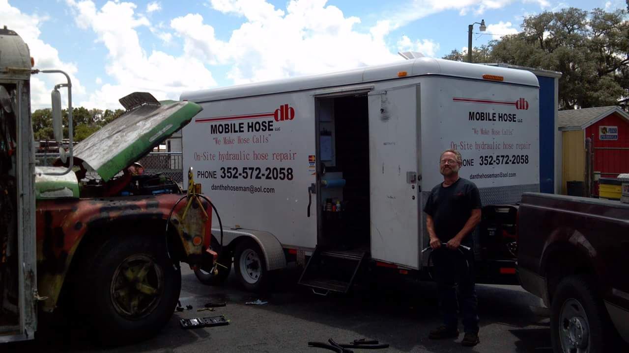 Man stands by a trailer with 