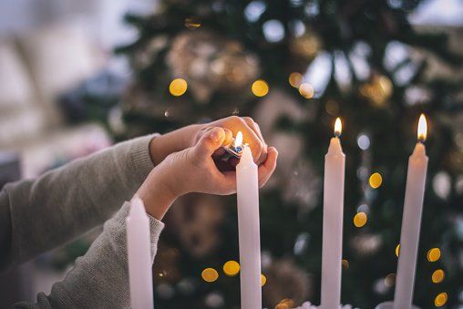 Someone lighting candles