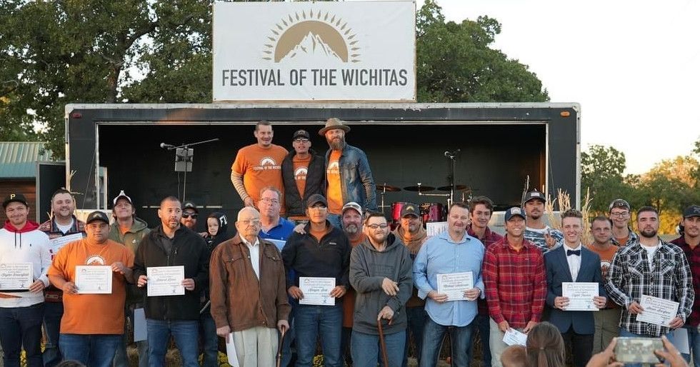A group of men standing in front of a sign that says festival of the michitas