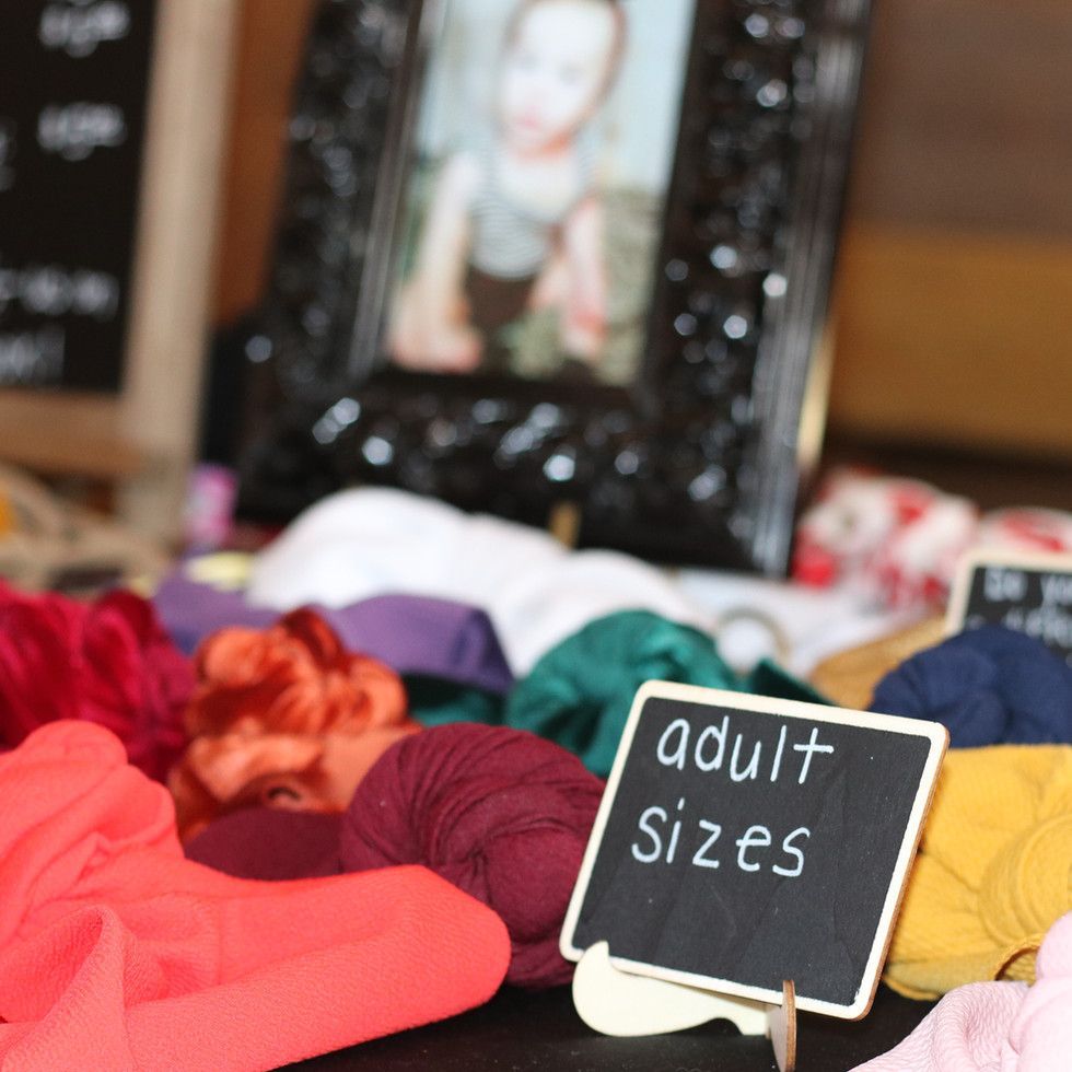 A sign on a table that says adult sizes