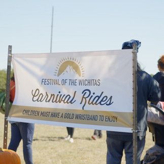 A sign for the festival of the wichitas carnival rides