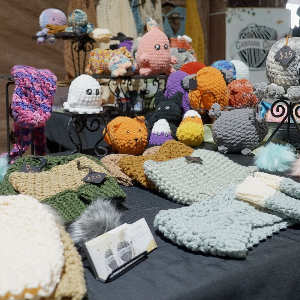 A table full of knitted items including hats and gloves