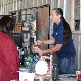 A man in a blue shirt is talking to a woman in a red sweater