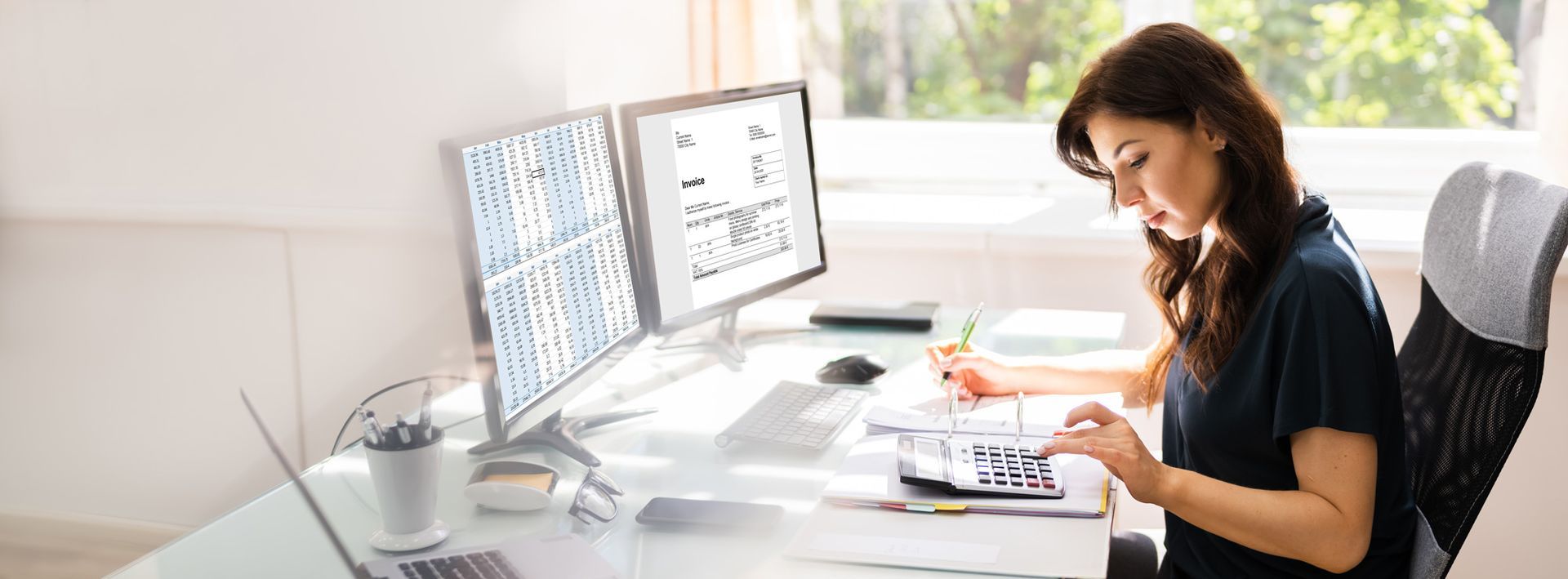 A table with papers and a laptop with the words about b & t financial group on it.