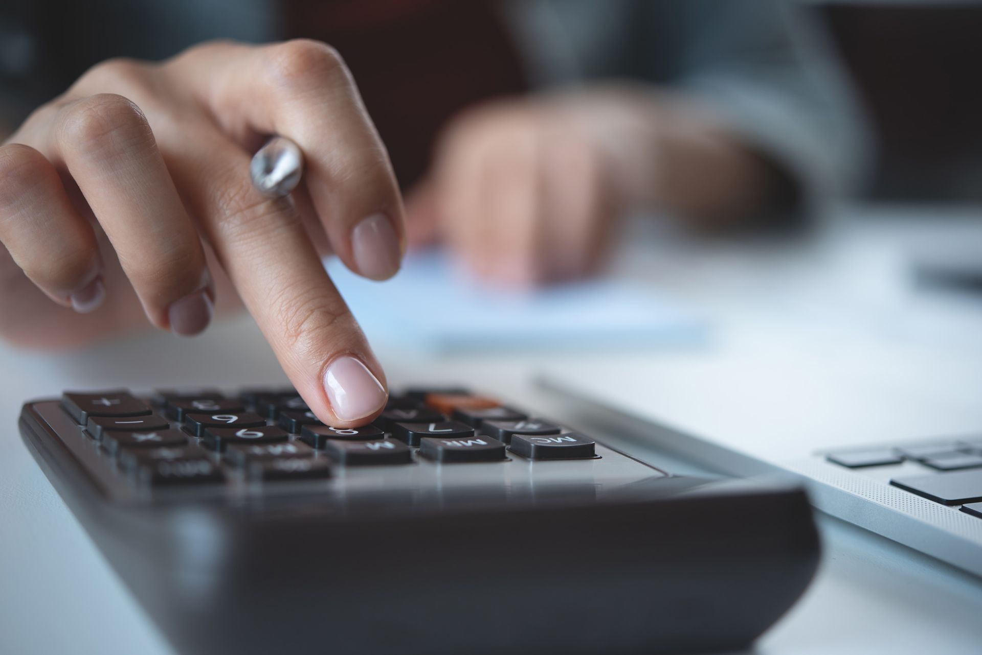 A close up of a person using a calculator.