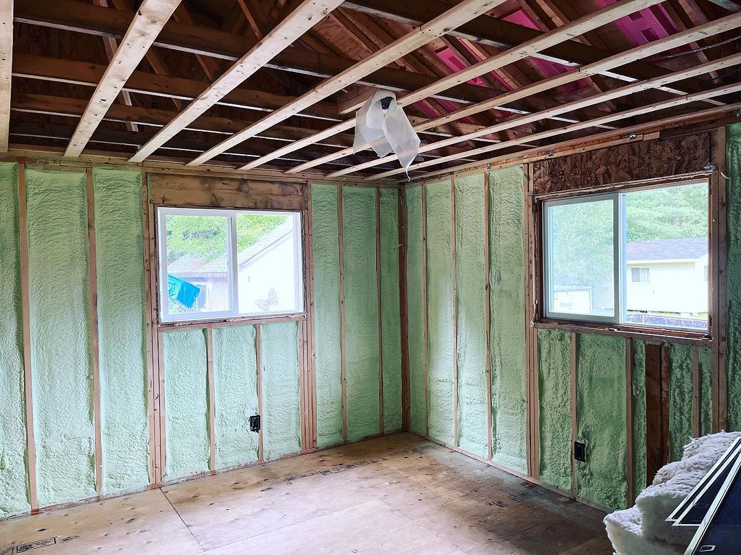 A room with green insulation on the walls and ceiling.