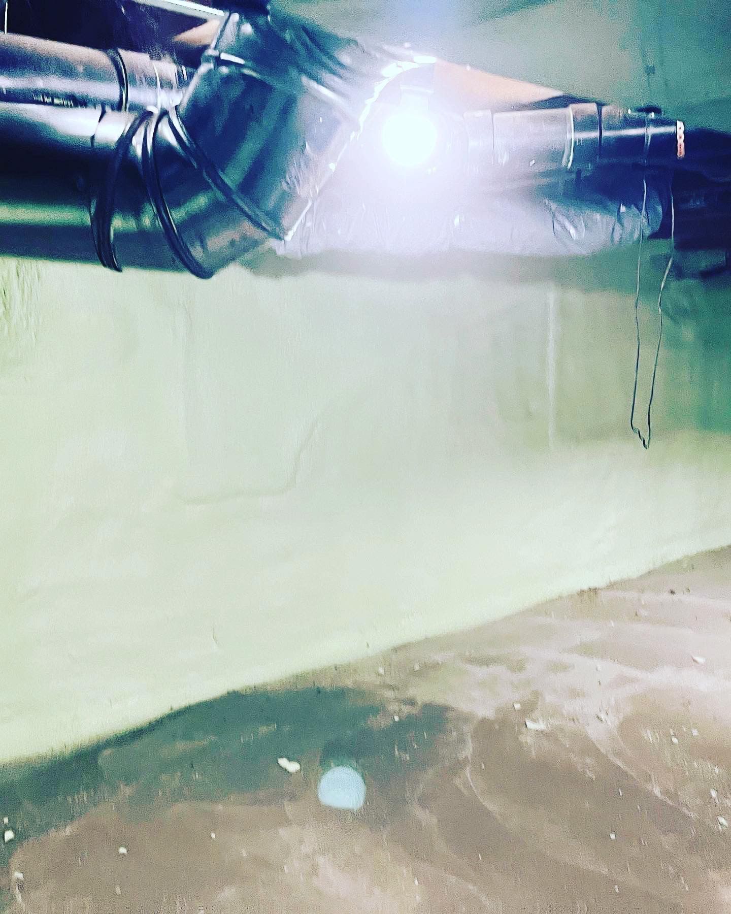 A pipe is hanging from the ceiling of a building