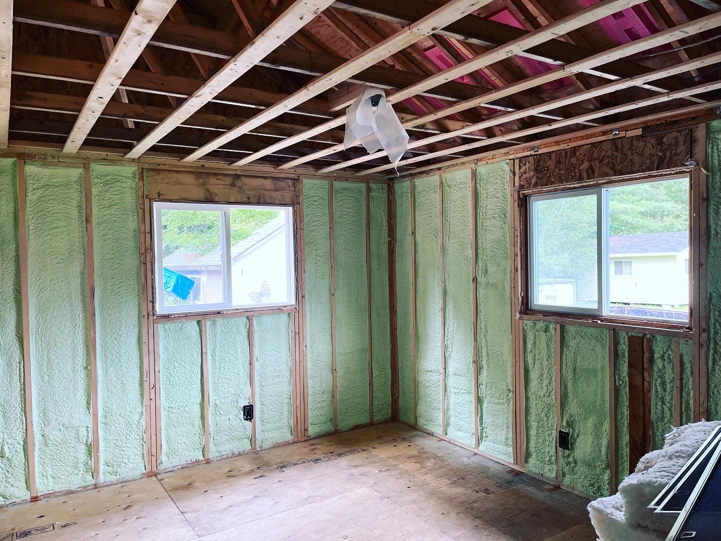 A room with green insulation on the walls and ceiling.