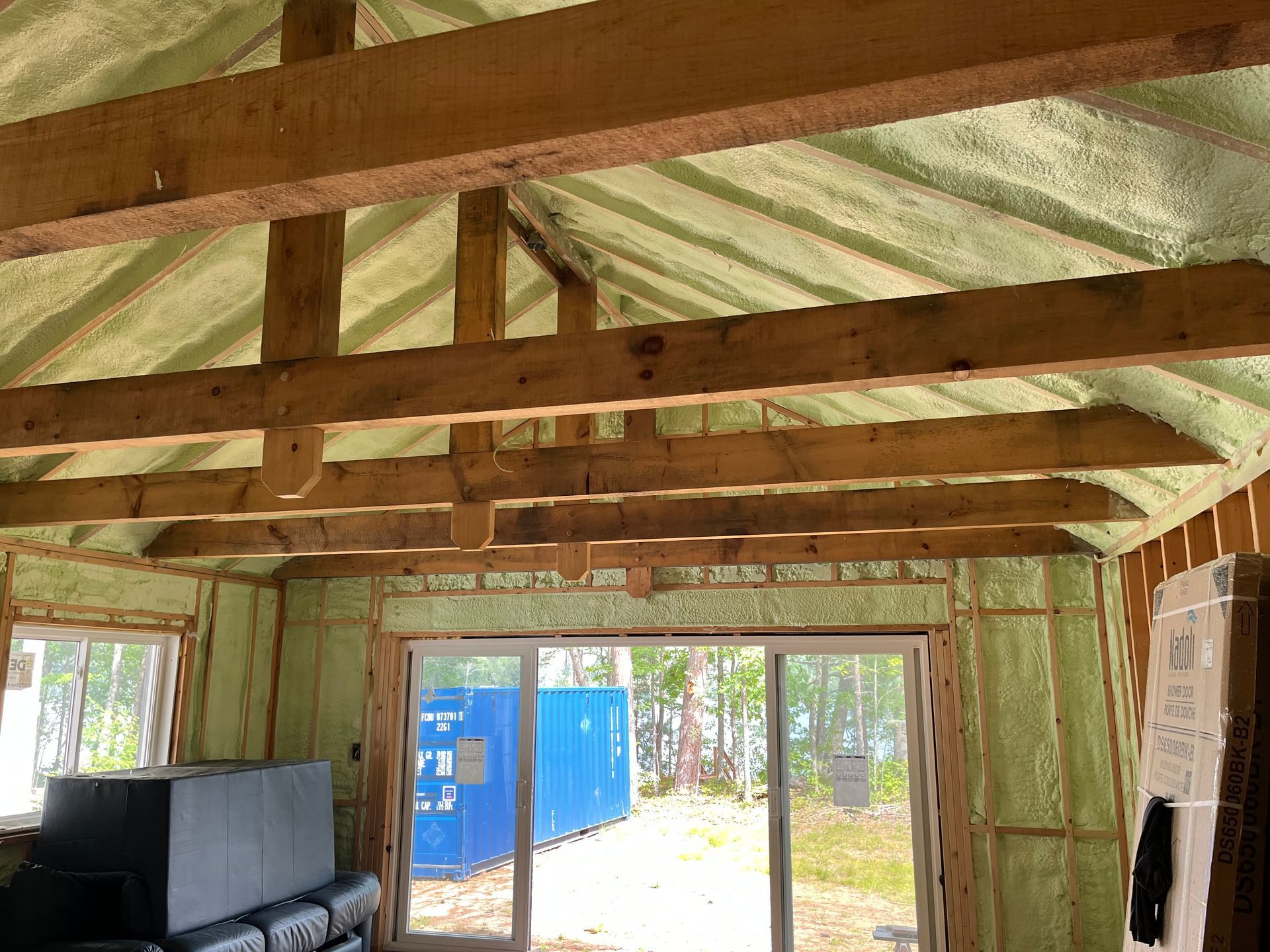 A room with a green ceiling and wooden beams.