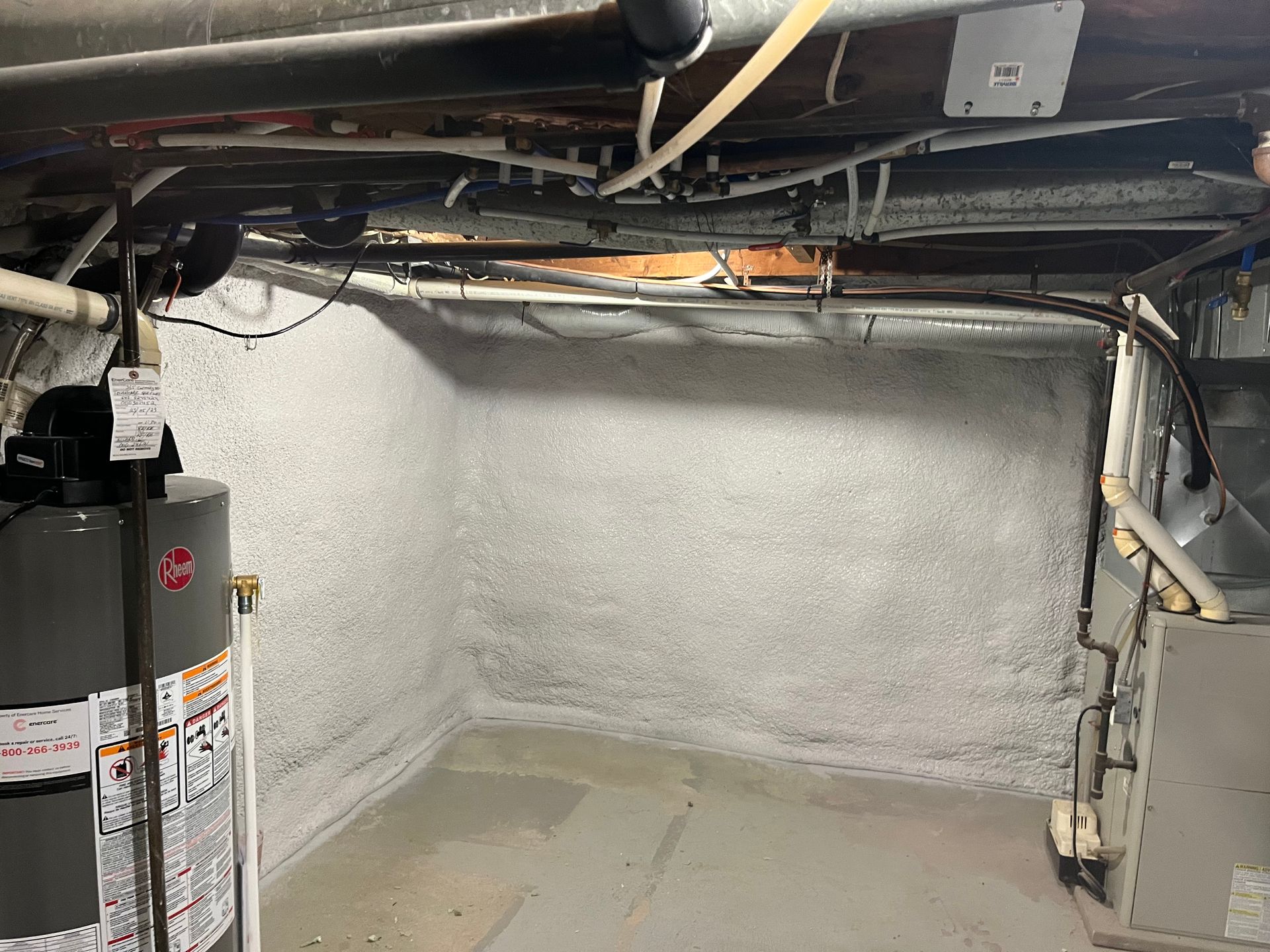 A basement with a water heater and a furnace.