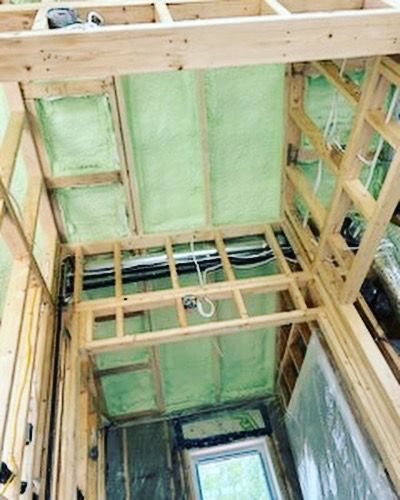 A room with a lot of wooden beams and insulation.