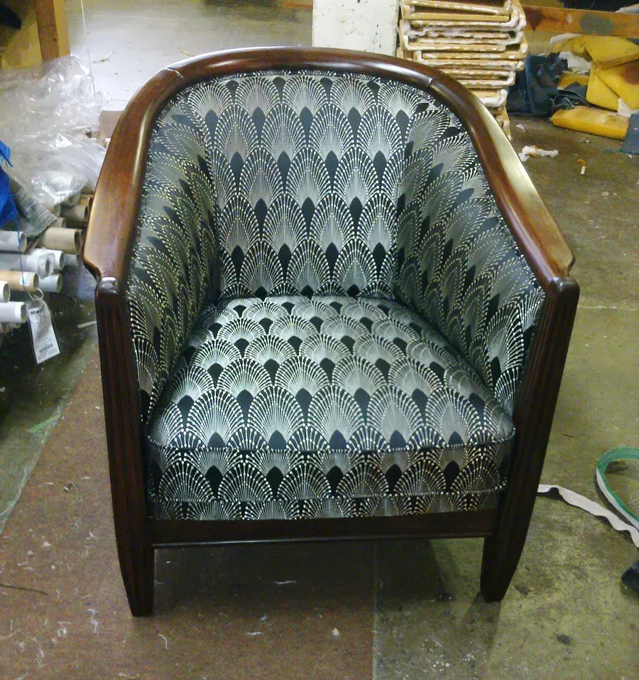 A chair with a pattern on it is sitting on the floor