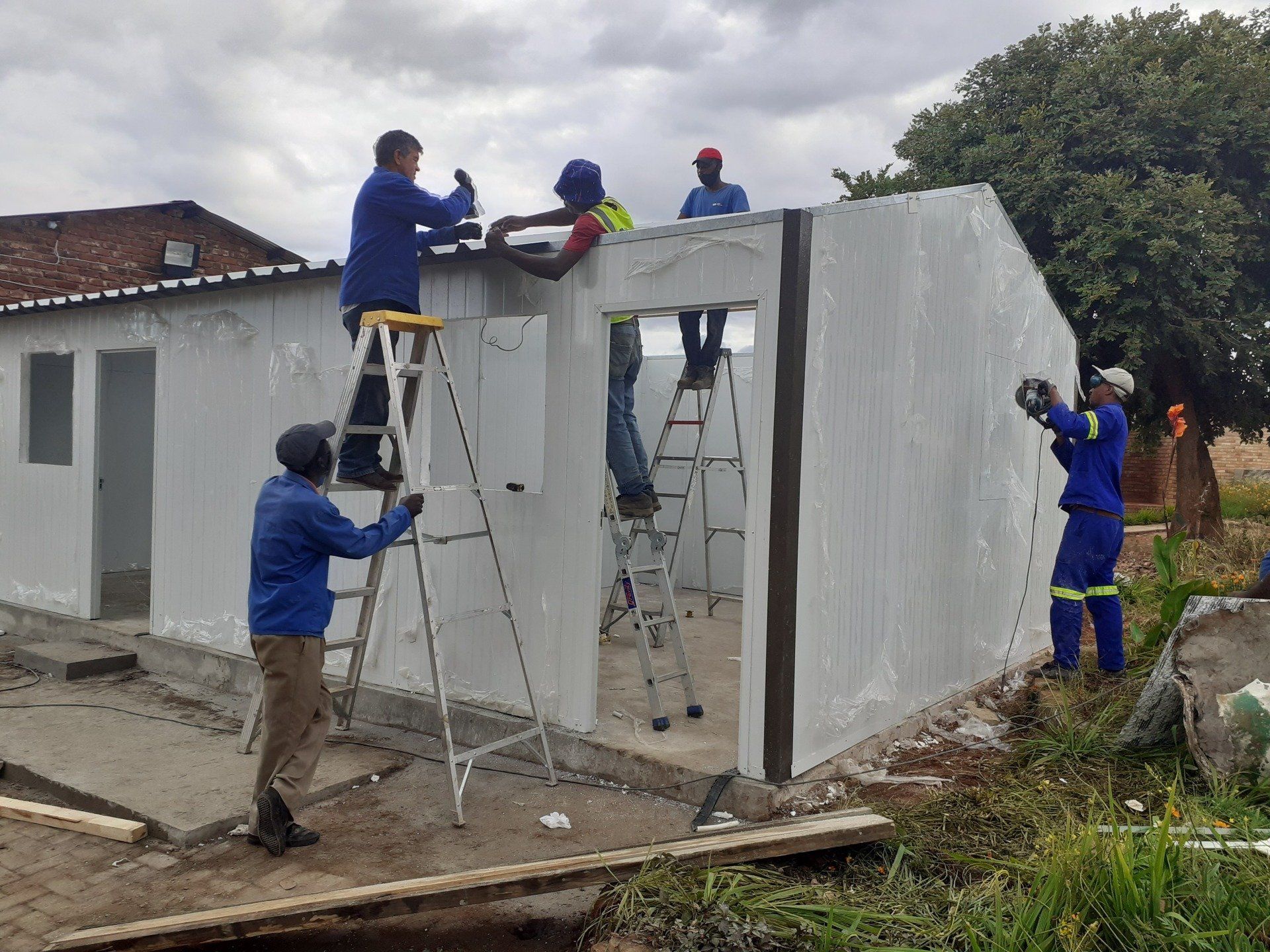A group of men are working on a building.