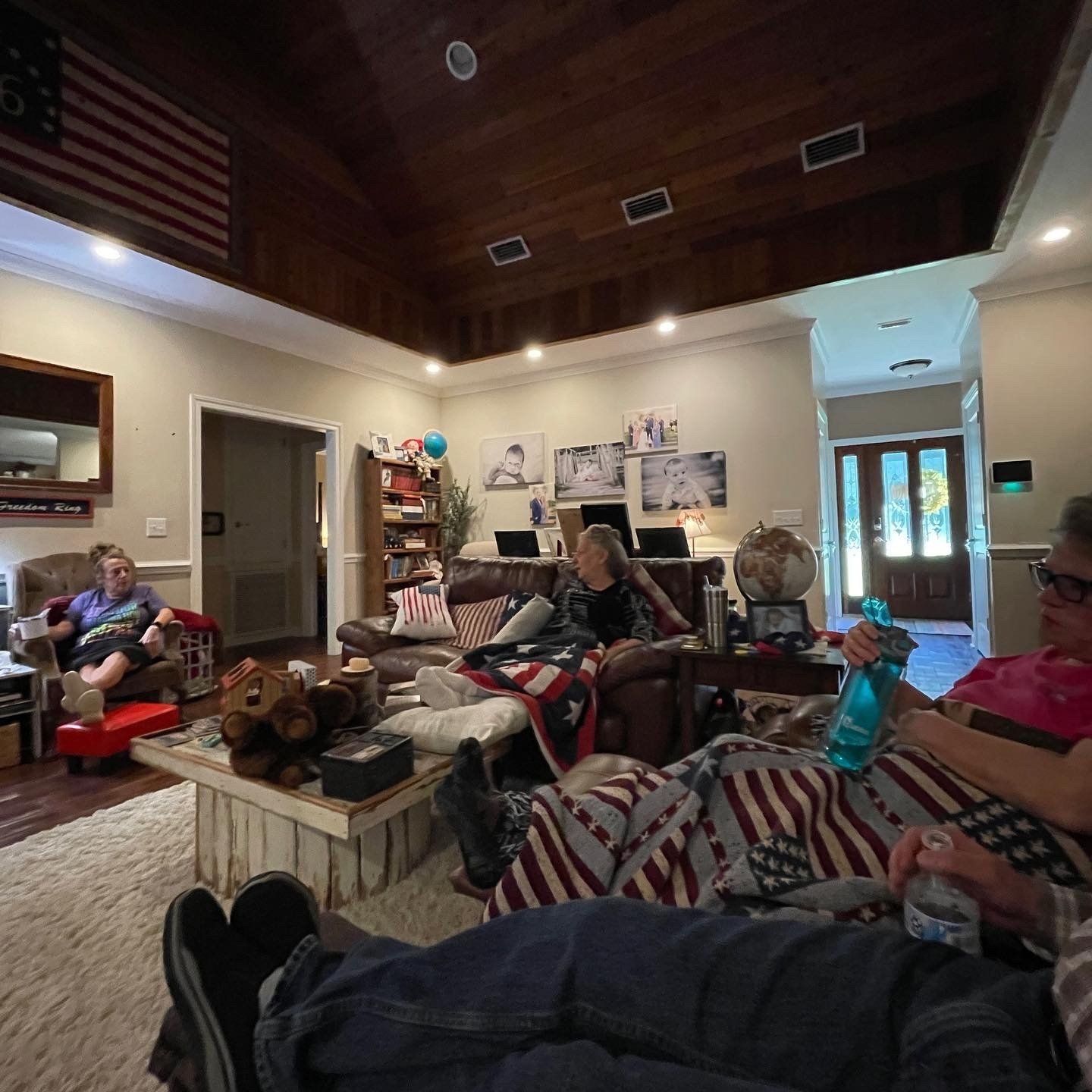 A group of people are sitting in a living room