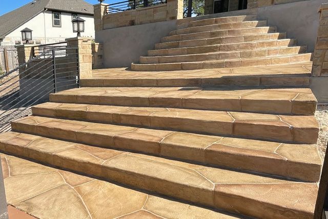Stone staircase leading up to a building, outdoor setting.