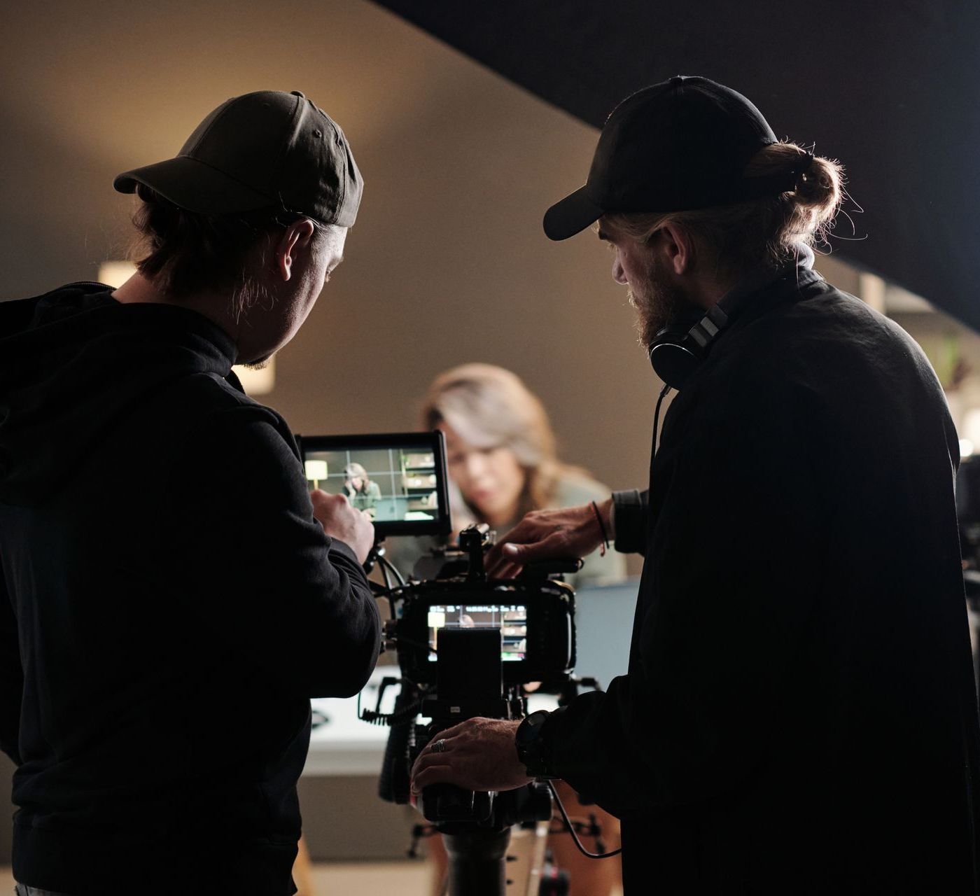 Back view of two young men standing in front of camera while shooting a Video Branding commerical To Increase Brand Awareness