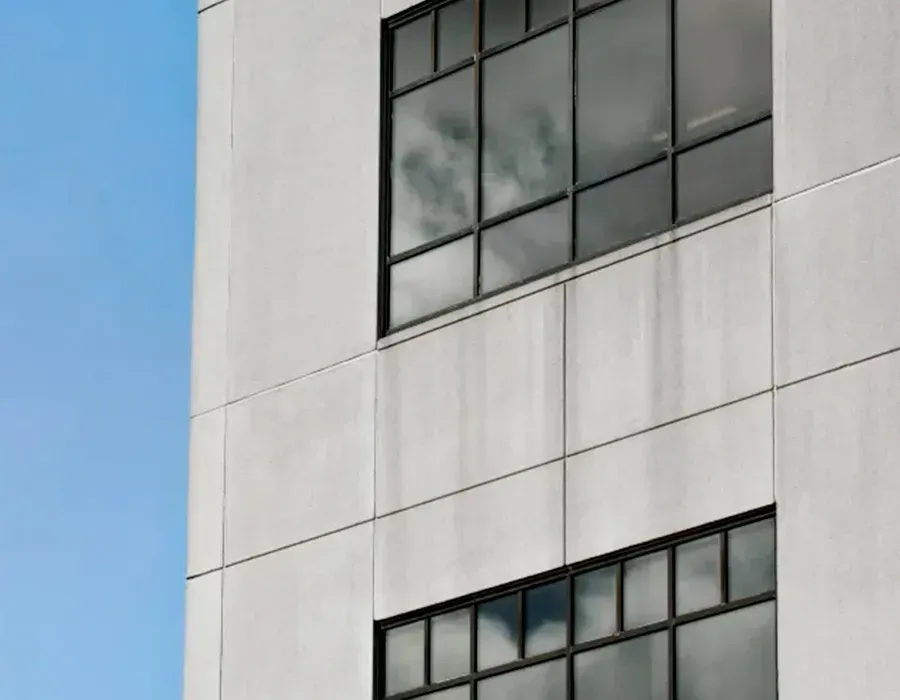 White building facade with large windows against a blue sky