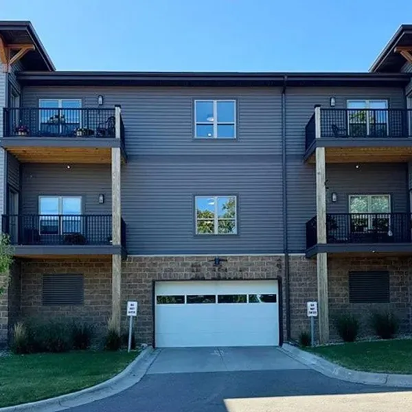 Apartment building exterior with balconies and a white garage door