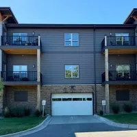 Apartment building exterior with balconies and a white garage door