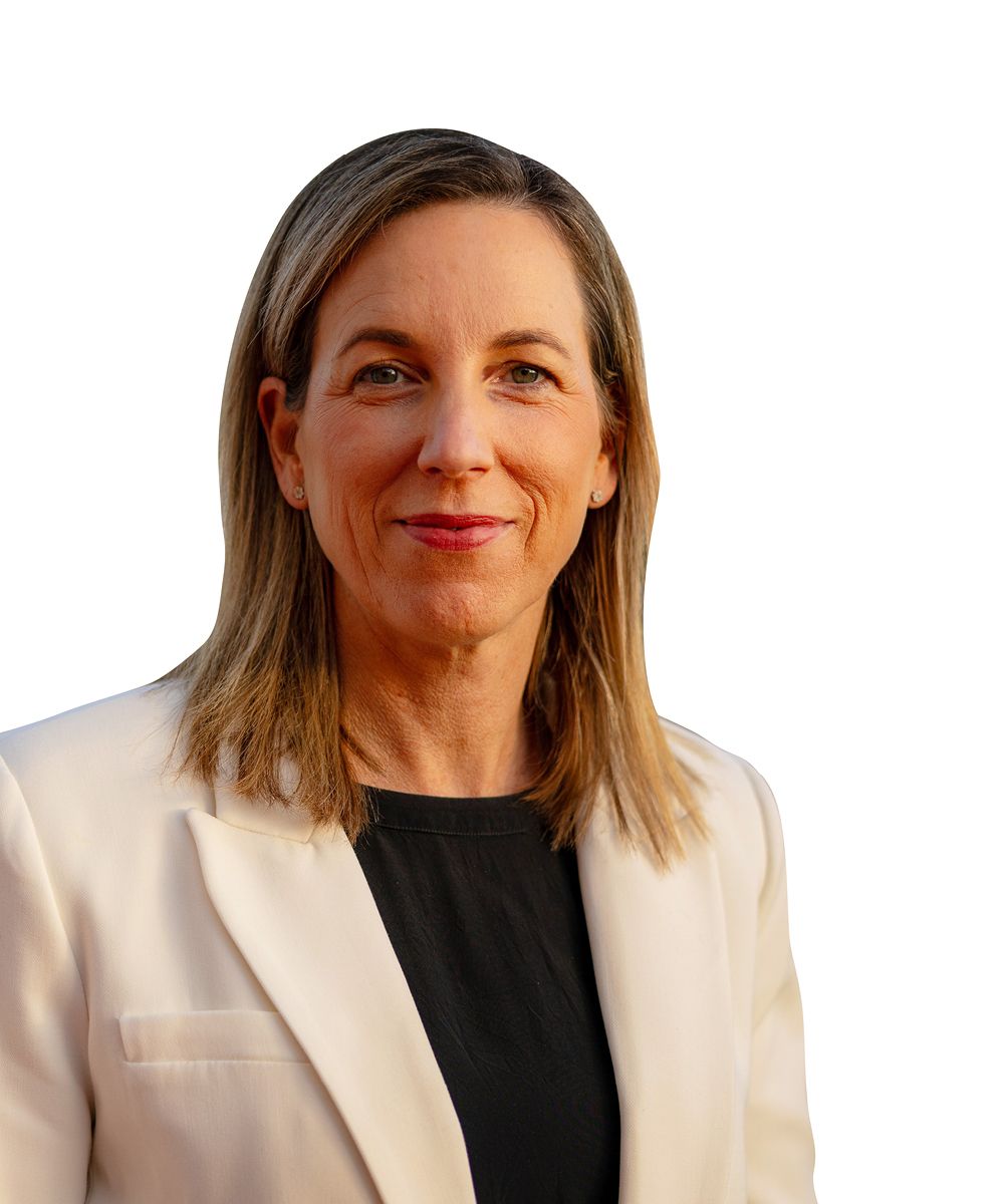 Portrait of a woman in a white blazer and black top against a white background