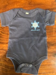 Dark gray baby onesie with a small blue sun graphic on a wooden surface