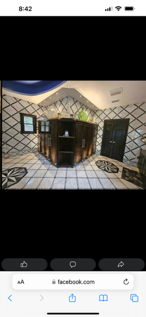Modern living room fireplace with black-and-white tiled hearth and diamond-pattern accent wall