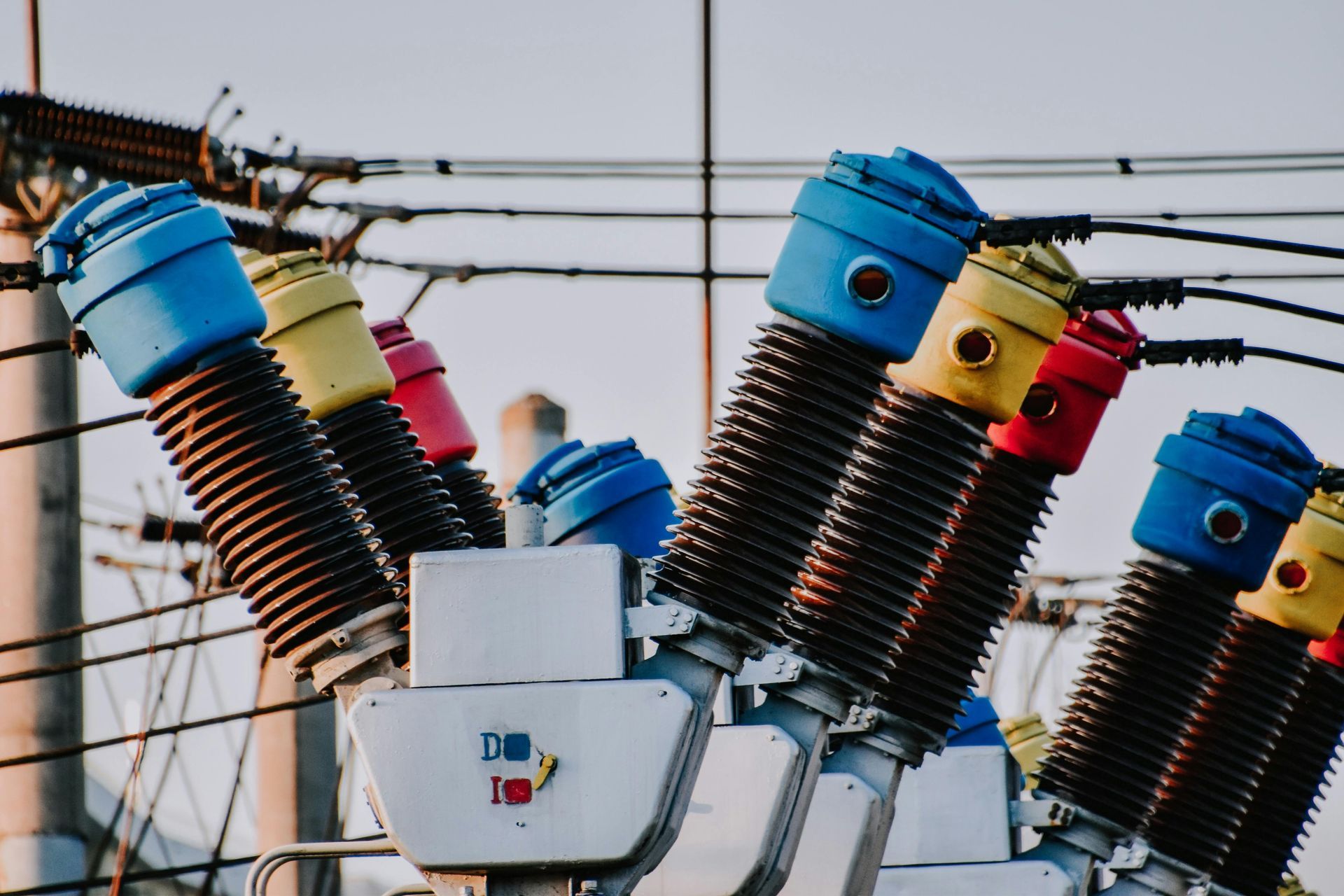 Insulators and power lines on an electrical utility pole against the sky