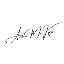 A black and white signature of ambre mckee free on a white background.