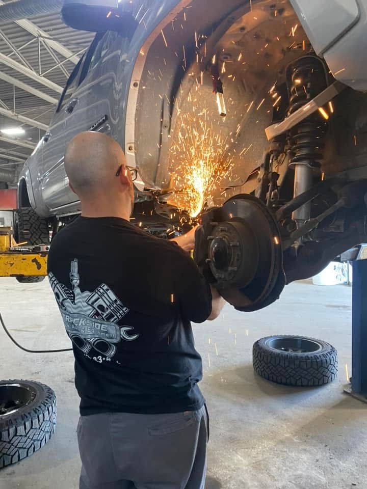 Technician Welding Under Truck During Equipment Repair | Trackside Truck Auto And Equipment