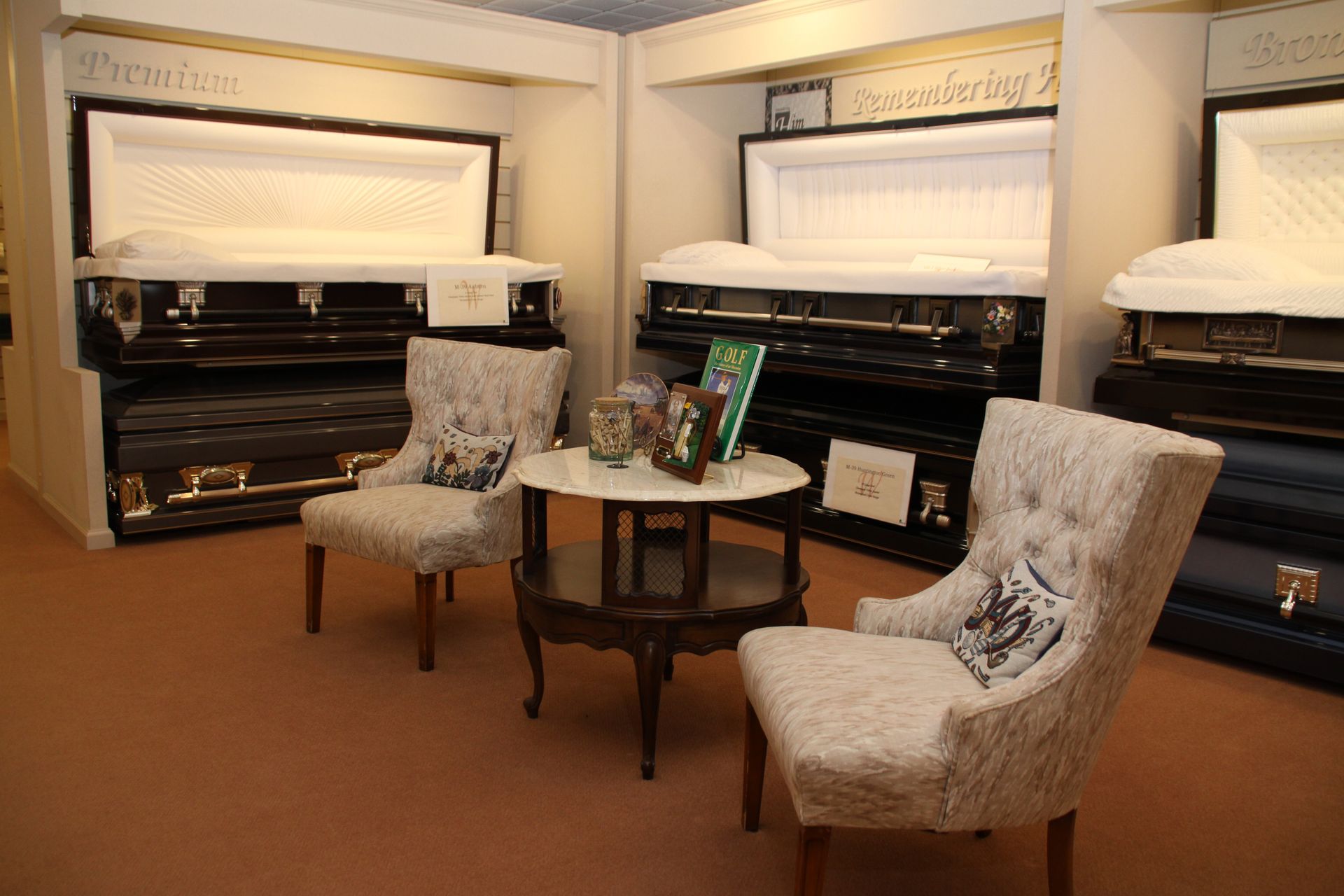 Furniture showroom with upholstered chairs, round tables, and display cabinets in a warm-lit room