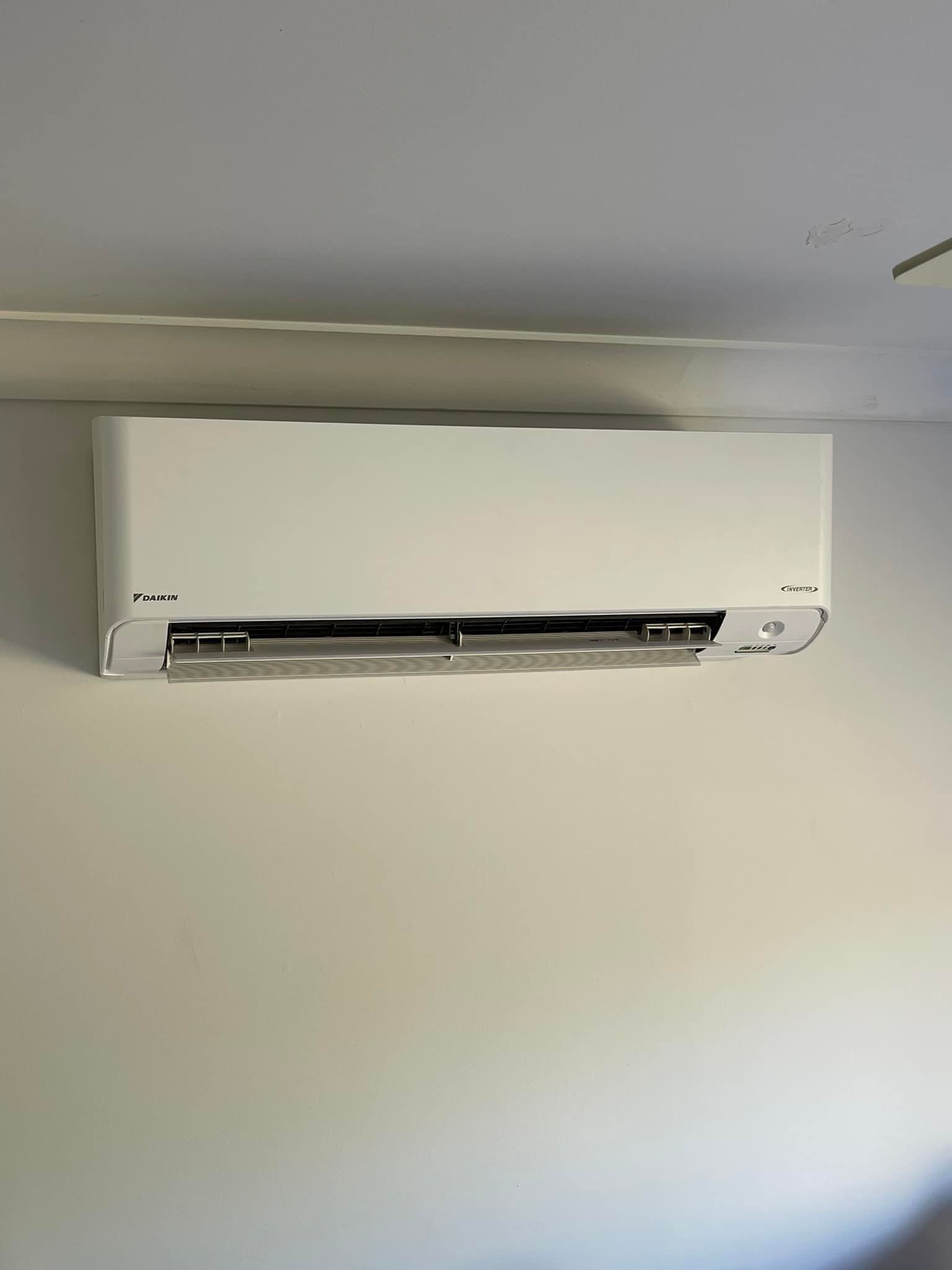 White Air Conditioning Unit Mounted on A White Wall — Canobolas Air in Orange, NSW