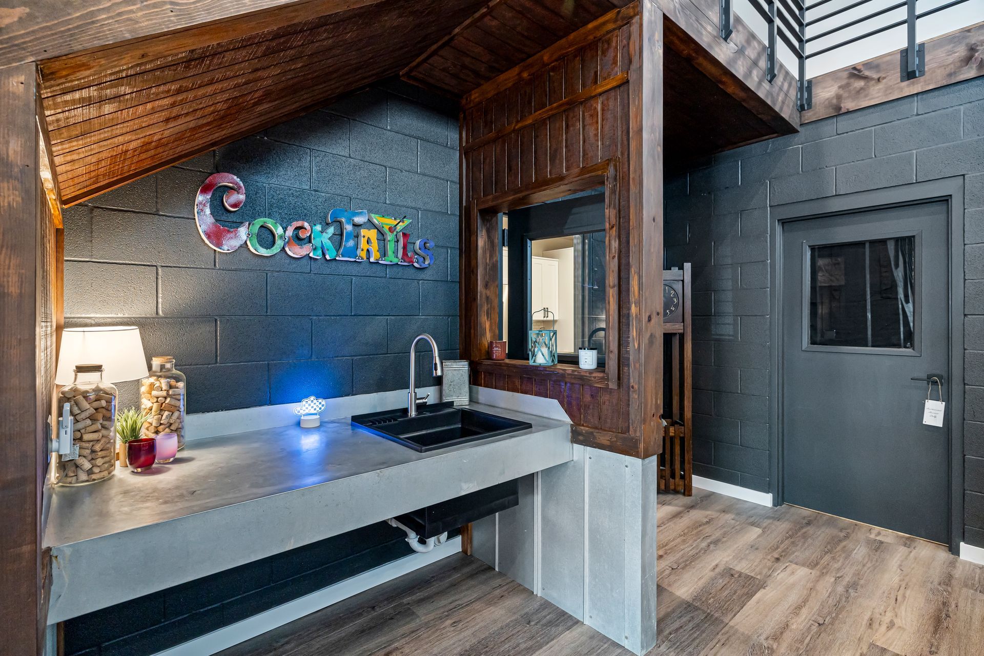 Modern office lobby with a reception desk, colorful wall sign, and wood-and-gray interior