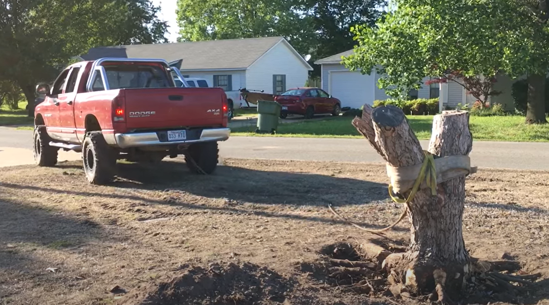 A red truck is parked in front of a house