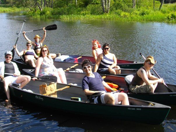 A group of people are in canoes on a lake