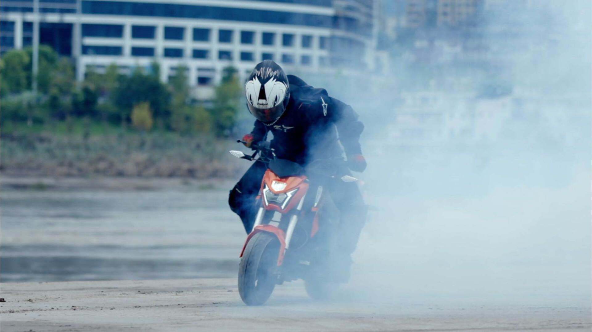 A man is riding a motorcycle on a dirt road.