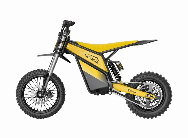 Yellow and black dirt bike with knobby tires, side view on white background