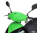 A close up of a green and black scooter on a white background.