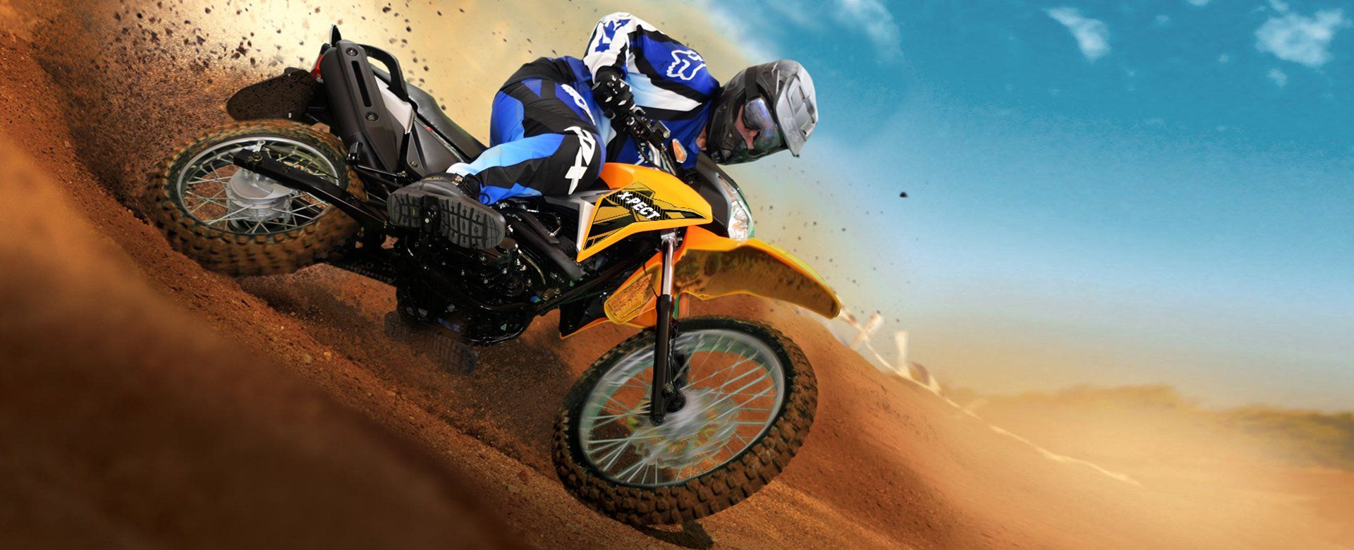 A man is riding a dirt bike down a dirt hill.