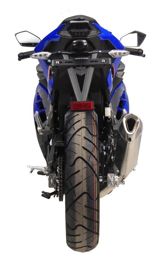 Rear view of a blue-and-black sport motorcycle with a centered rear tire and chrome exhaust