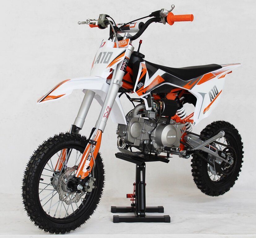 White and orange dirt bike on a stand, side view against a plain white background.