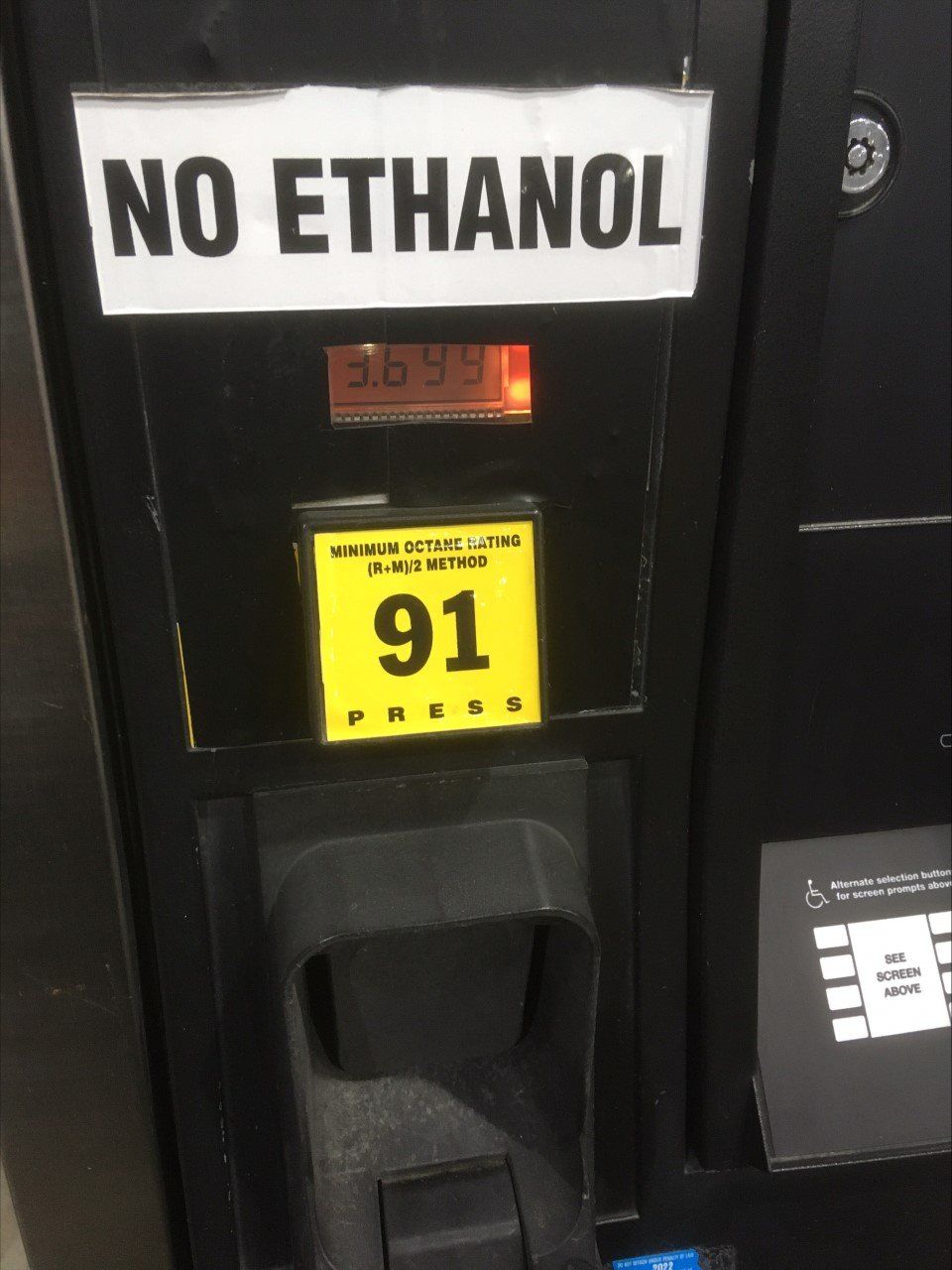 A gas pump with a no ethanol sign on it