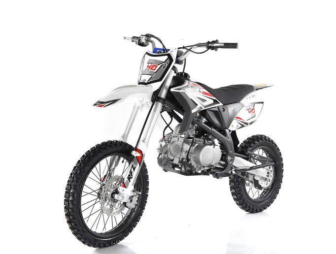White dirt bike with knobby tires, silver frame, and red-black decals on a white background