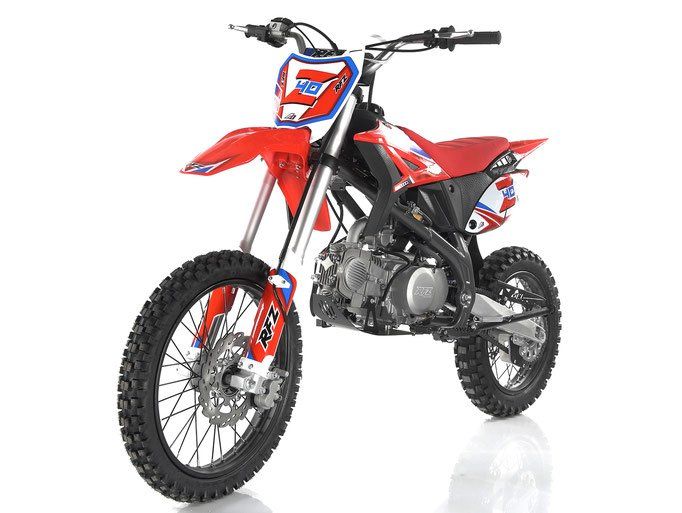 Red off-road dirt bike on a white background, angled front-left view with knobby tires and black seat
