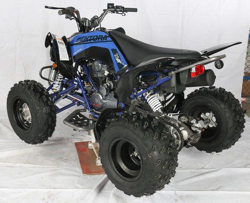 A blue and black atv is sitting on a white surface