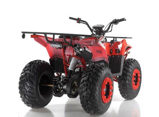 Red all-terrain quad bike with large tires and rear cargo rack on a white background