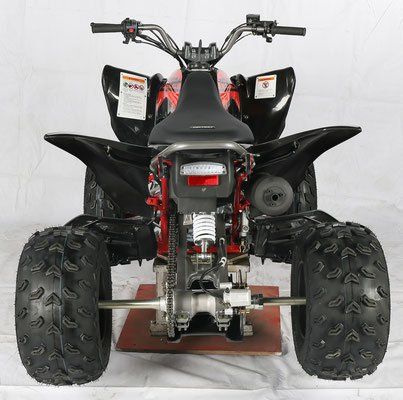 Rear view of a black red ATV with large knobby tires on a white background