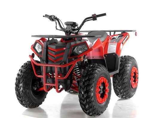 Red and black four-wheeled ATV with oversized tires on a white background