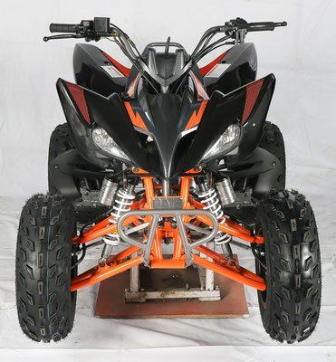 Front view of a black and orange ATV with large knobby tires on a white background